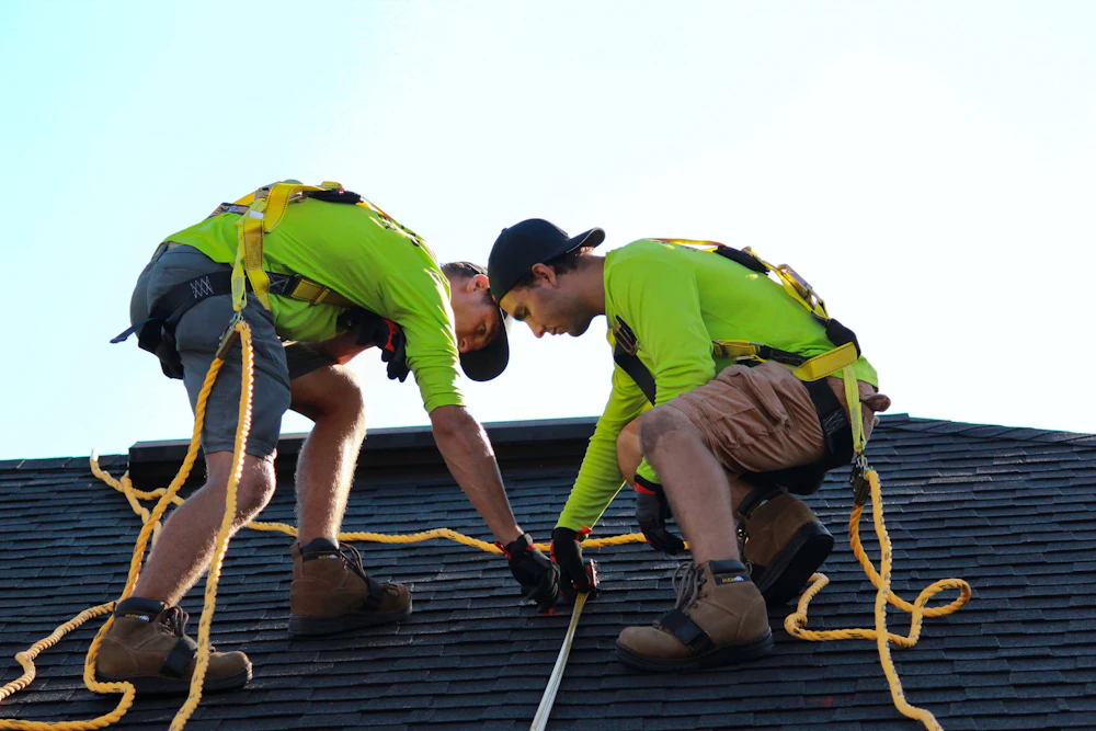 Two roofers working on a roof